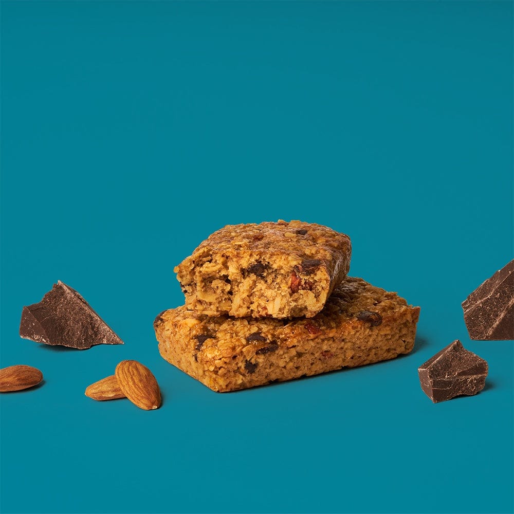 A close-up of a Dark Chocolate Almond with Sea Salt Oat Bar, showcasing whole grain oats, dark chocolate, almonds, and nuts. Gluten-free, vegan, and dairy-free snack.