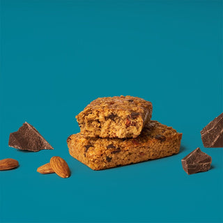A close-up of a Dark Chocolate Almond with Sea Salt Oat Bar, showcasing whole grain oats, dark chocolate, almonds, and nuts. Gluten-free, vegan, and dairy-free snack.