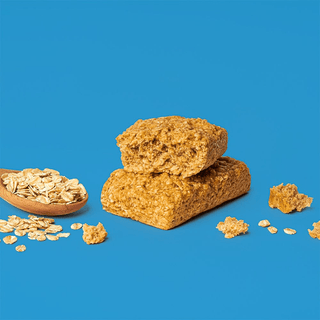 Bobo's Original Oat Bar split in half on a blue background