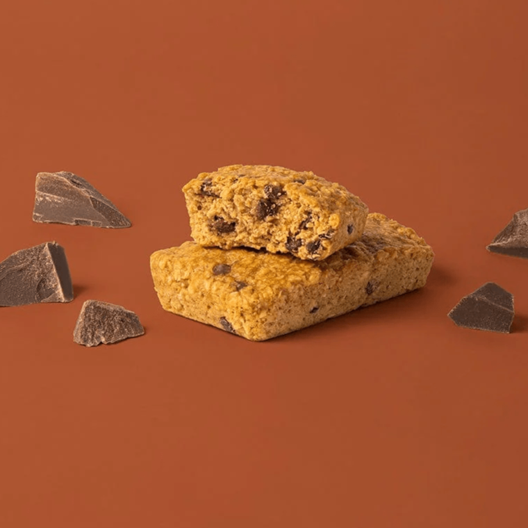 Bobo's Chocolate Chip Oat Bar split in half on a brown background