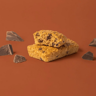 Bobo's Chocolate Chip Oat Bar split in half on a brown background