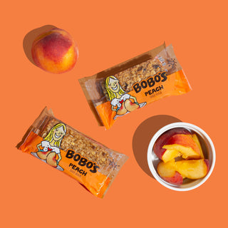 A close-up of a Peach Oat Bar, showcasing wholesome oats and juicy peaches.