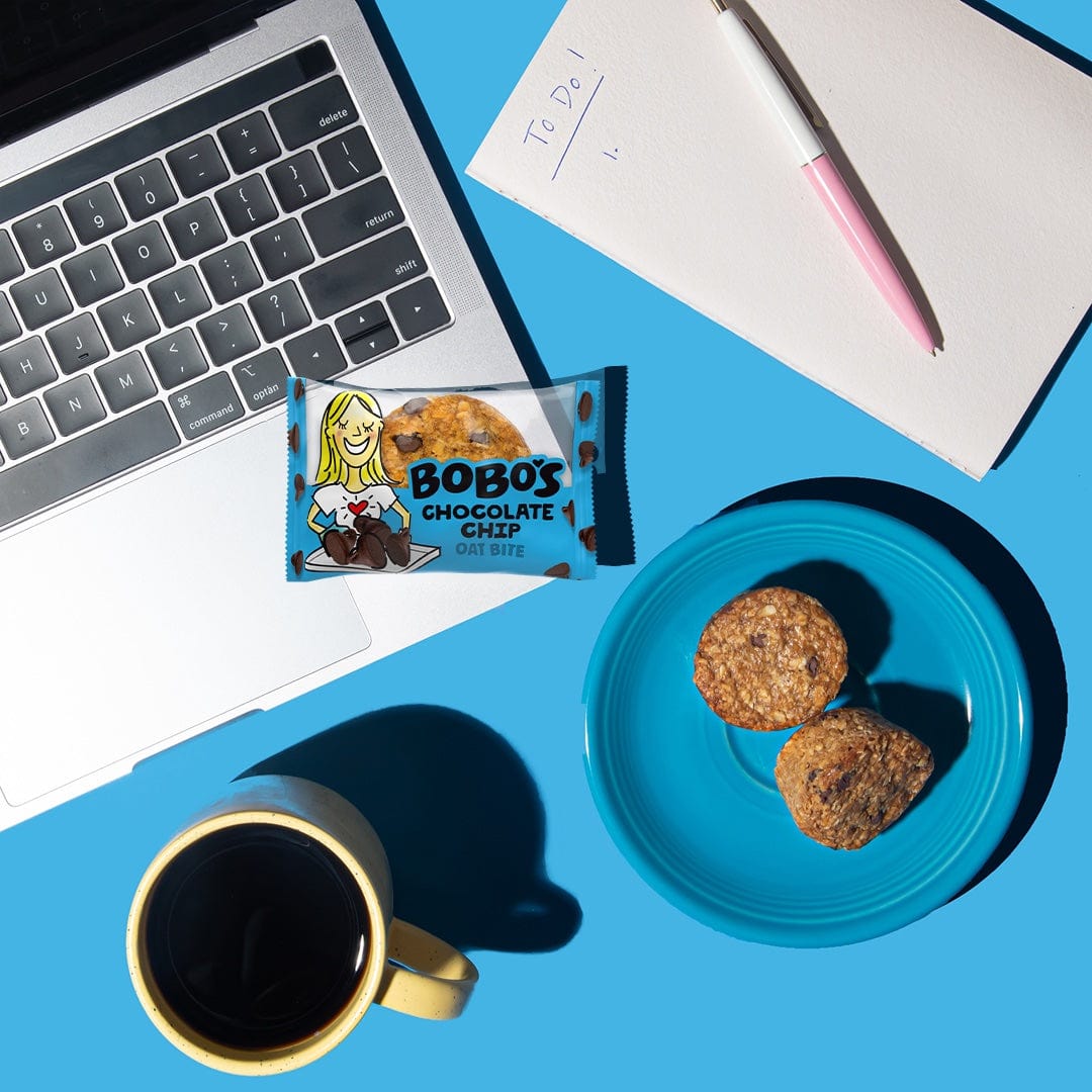 Oat bite on blue background with surrounding laptop