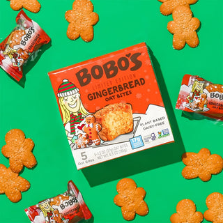 Oat bite on green background with surrounding gingerbread cookies