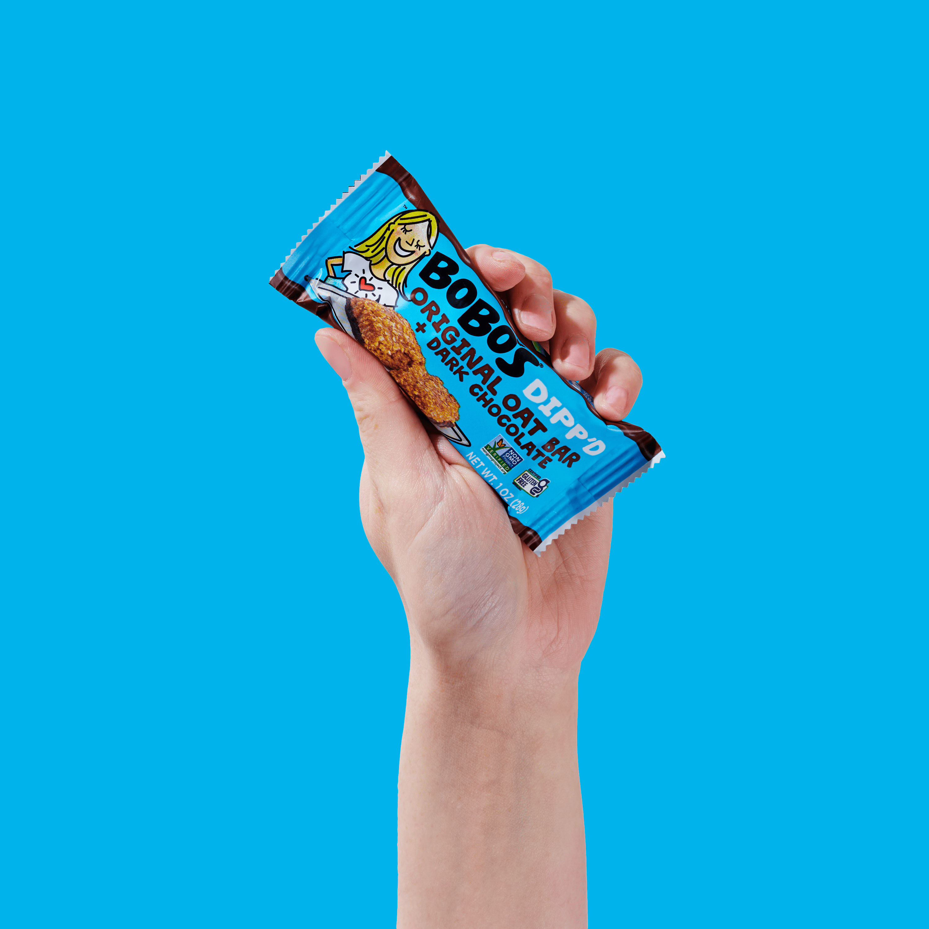 Oat bar on blue background with surrounding chocolate chunks