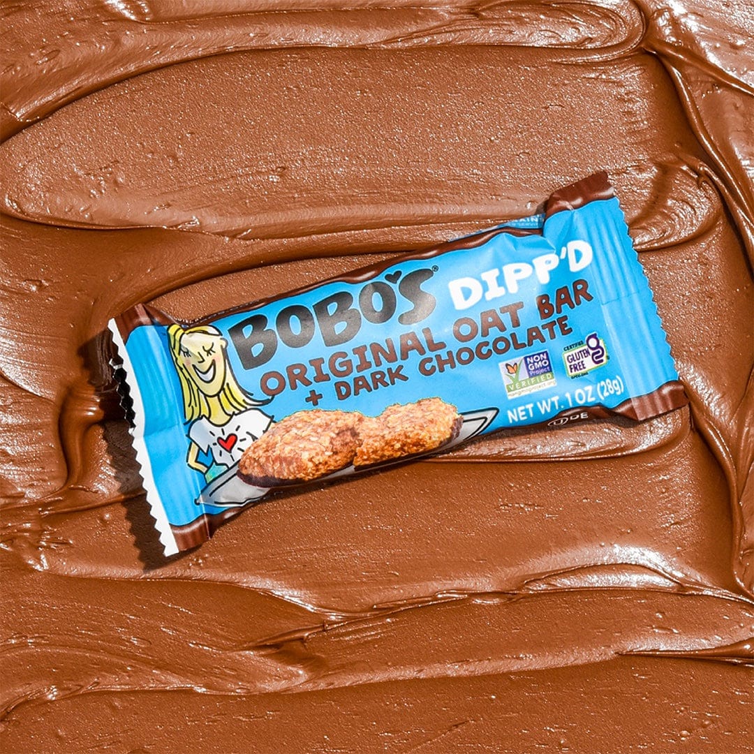 Oat bar on chocolate background