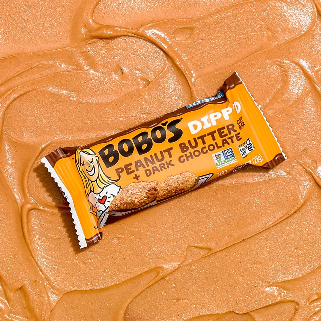 Oat bar on peanut butter background