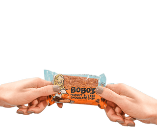 Two hands holding a Peanut Butter Chocolate Chip Bobo's bar
