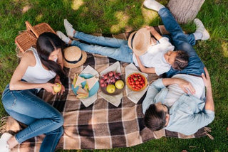 A family is having a healthy picnic snack with Bobo's Oat Bars