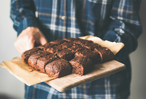 Person holding a tray of vegan brownies