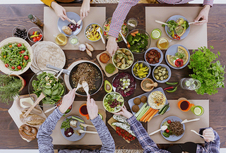 Group of people around a table serving themselves food