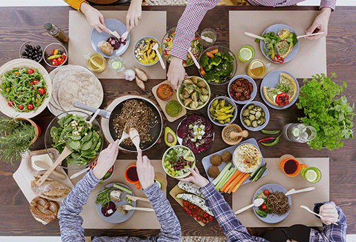 Group of people around a table serving themselves food