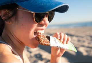 woman eating healthy protein bar