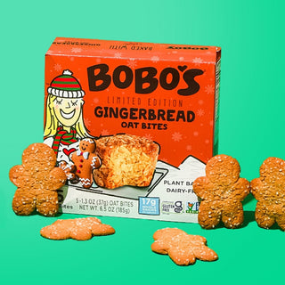 Oat bite on green background with surrounding gingerbread cookies