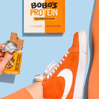Protein bar on blue background with a shoe in the frame