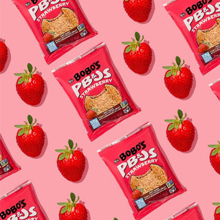 PB&J oat snack on pink background with surrounding strawberries and peanut butter