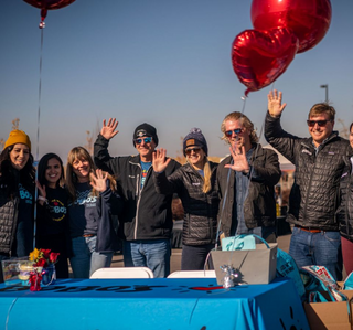 Bobo's Founders standing behind a table waving