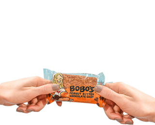 Two hands holding a Peanut Butter Chocolate Chip Bobo's bar