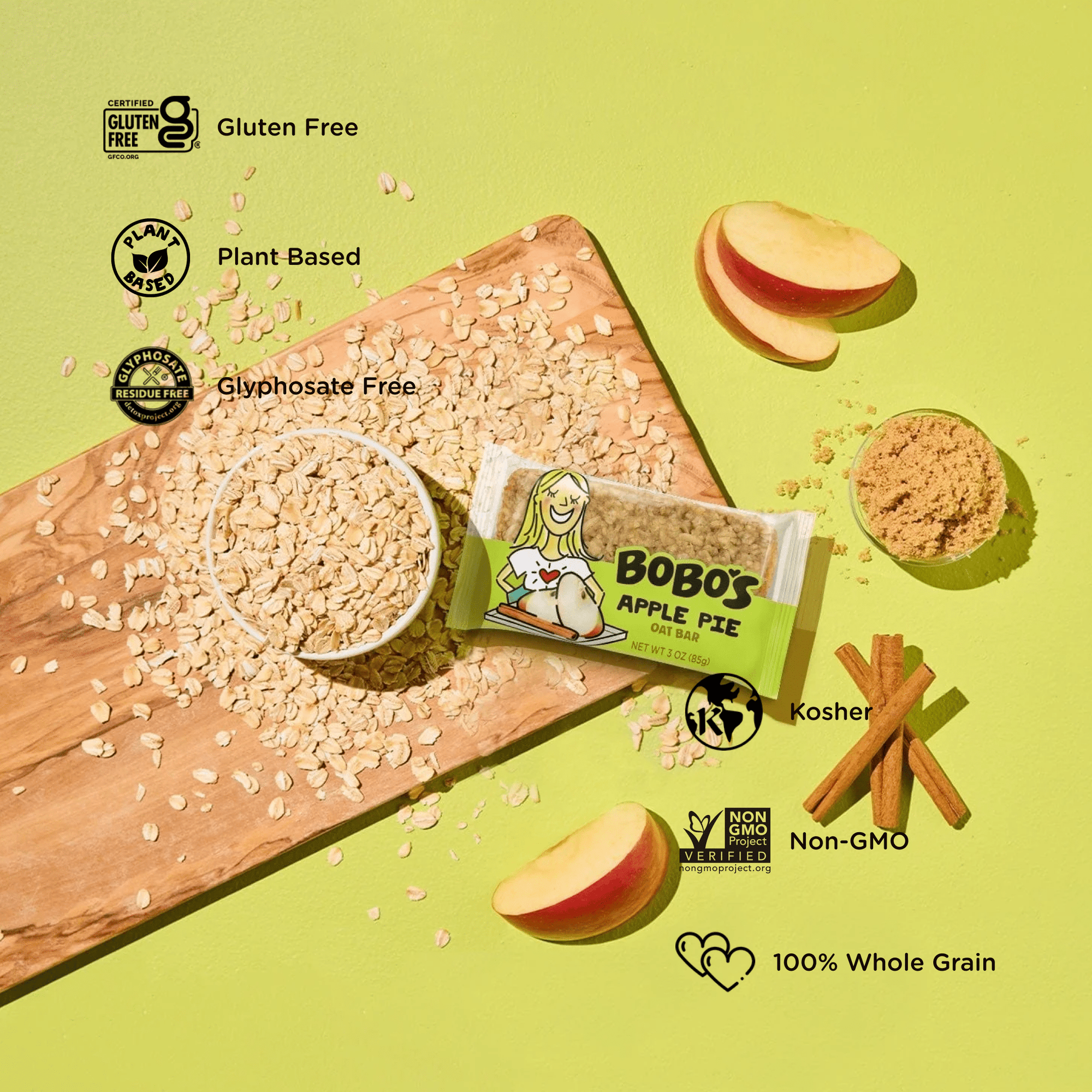 Oat bar on green background with surrounding apples and cinnamon