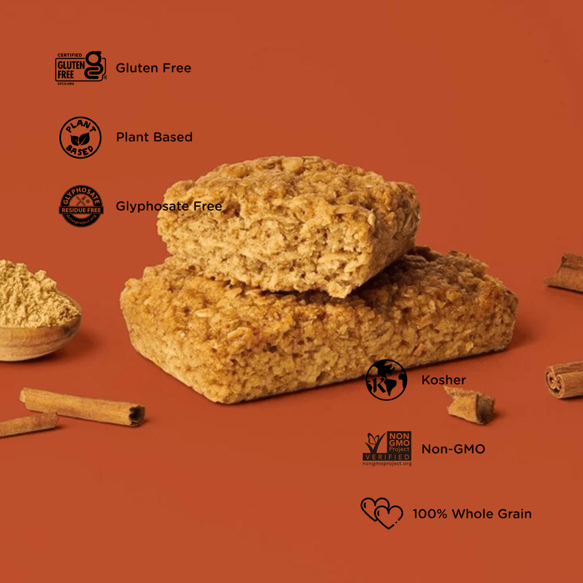 Oat bar on brown background with surrounding ginger and cinnamon